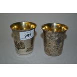 Two Russian silver vodka beakers,