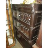 Globe Wernicke ebonised oak three section bookcase with two leaded glass doors and a single panel