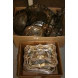 Two boxes containing a quantity of various silver plated items including: entree dishes,