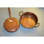 Circular copper and brass warming pan with a turned wooden handle