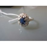 Platinum sapphire and diamond set oval cluster ring