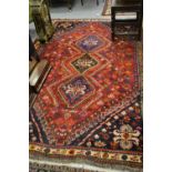 Shiraz rug with triple medallion on a red ground with borders,