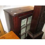Regency mahogany single door side cabinet having bar glazed door enclosing shaped shelves on turned