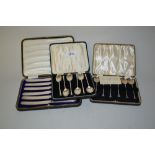 Two cased sets of six silver seal handled coffee spoons and a set of six silver handled tea knives