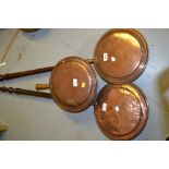 Three 19th Century copper warming pans (one minus handle)