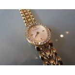 Bucherer ladies 18ct gold cased wristwatch with diamond set bezel and integral bracelet strap