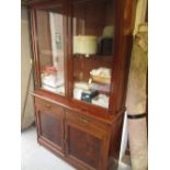Victorian mahogany bookcase with a moulded cornice above two glazed doors,