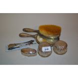 Silver backed brush and mirror, three silver lidded dressing table jars,
