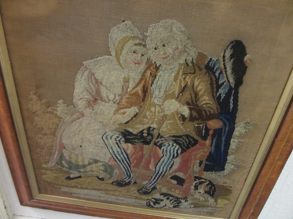 19th Century needlework picture of a seated lady and gentleman in a maple frame together with