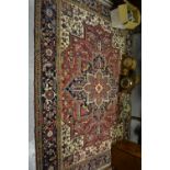 Heriz rug with geometric centre medallion and all-over floral design on multiple borders,