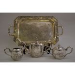 Chinese silver three piece tea service together with a Chinese silver octagonal two handled tray