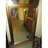 Modern rectangular gilt framed wall mirror with bevel edged plate