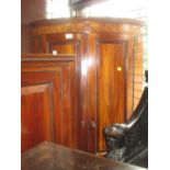 George III mahogany two door bow fronted hanging corner cabinet