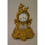 19th Century French ormolu mantel clock with cherub supports, the enamel dial with Roman numerals,