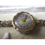 Ladies 9ct gold wristwatch with silvered dial having Arabic numerals in fitted box