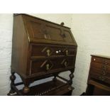 Early 20th Century oak bureau with a geometric moulded fall front above two similar drawers on