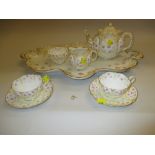 George Jones crescent china tea service for two decorated with roses and gilding including a large