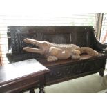 19th Century carved oak hall bench having three panel back above a box seat with hinged cover on