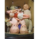 Box containing a quantity of various injection moulded dolls