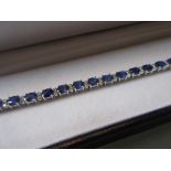 18ct White gold sapphire and diamond line bracelet, the sapphires approximately 11.