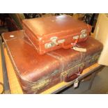 Leather travel case with fitted interior together with another small brown suitcase