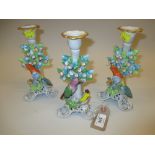 Pair of Sitzendorf porcelain candlesticks mounted with flowers and birds together with another