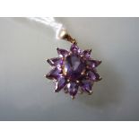 Small 9ct gold amethyst coloured and diamond chip mounted pendant