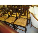 Set of seven (six plus one) 19th Century elm dining chairs with rail backs and rush seats