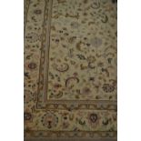 Modern carpet with all-over floral decoration and multiple borders on a cream ground with pastel