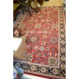 Indo Persian rug of floral and trellis pattern with multiple borders on a burgundy ground,