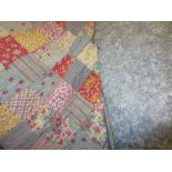Patchwork double bed quilt and a pair of pinch pleated pale blue full length curtains