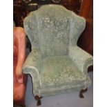 20th Century wing armchair in 18th Century style having teal coloured floral upholstery on carved