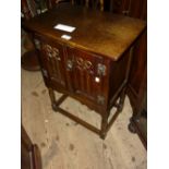 Small reproduction oak two door side cabinet together with a nest of three oak occasional tables