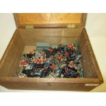 Wooden box containing a quantity of various lead soldier toys
