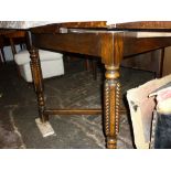 Mid 20th Century square oak draw-leaf table on turned supports with crossover stretcher