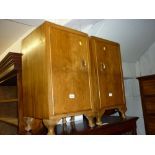 Pair of walnut single door bedside cabinets on low cabriole supports