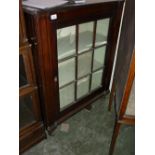 Regency mahogany single door side cabinet having bar glazed door enclosing shaped shelves on turned