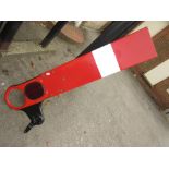 Red and white British Rail signal arm with red and black iron mount
