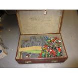 Suitcase containing a collection of various plastic toy soldiers and a castle