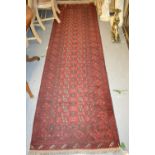 Afghan runner having red ground with multiple borders and a modern Chinese carpet on a beige ground