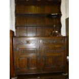 Good quality reproduction oak dresser having shelved back above two carved drawers and two three