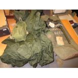 Post World War II green kit bag containing: gas masks, sleeping bag, rain cape, ground sheet,