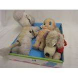 Mid 20th Century clockwork toy dog together with an early Merrythought toy dog and a Kewpie doll