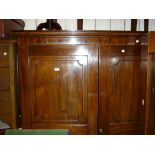 Early 19th Century mahogany side cabinet with a moulded cornice above two panelled doors enclosing