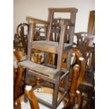 George III oak child's high chair with a ladder back above panel seat,