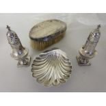 Silver shell form dish together with a pair of Birmingham silver peppers and a silver backed brush