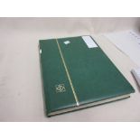 Green album containing a collection of Trinidad and Tobago stamps from First Issues to Q.E.