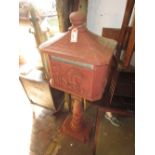 20th Century cast iron red painted letter box, decorated in high relief with a figure on horseback,