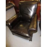 Black leather upholstered club chair on turned bun feet