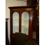 Late Georgian mahogany standing corner cabinet with a moulded cornice above a pair of glazed doors